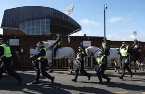 Millwall marah setelah buklet anti-rasisme menunjukkan lencananya pada jubah Ku Klux Klan